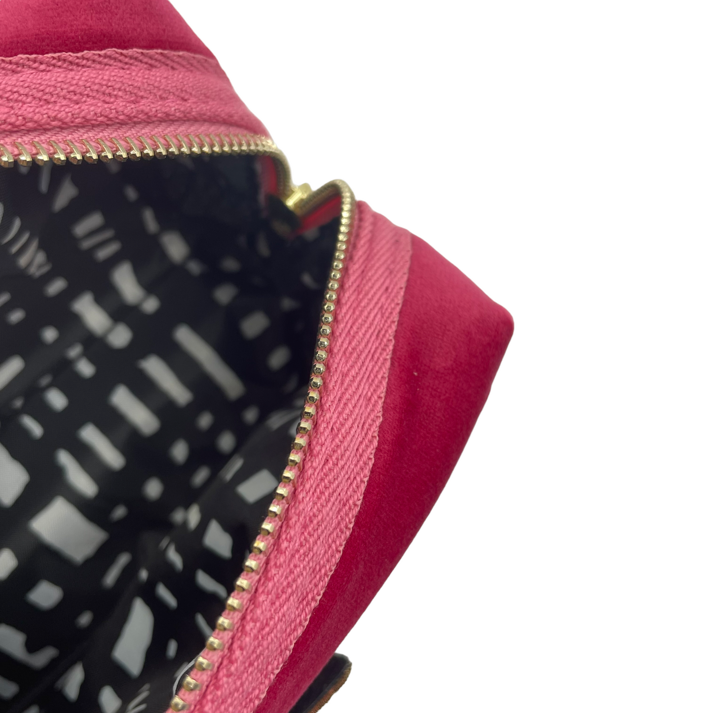 Bright pink makeup bag with Tiger Head brooch