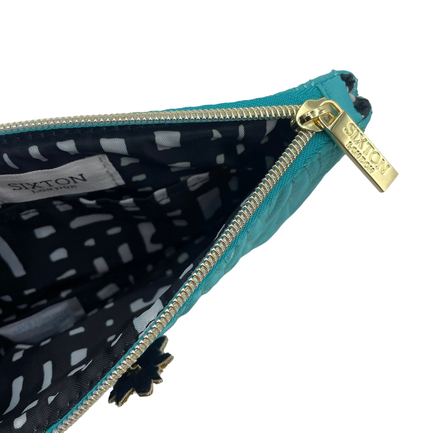 Turquoise Tribeca make up bag with a pineapple pin