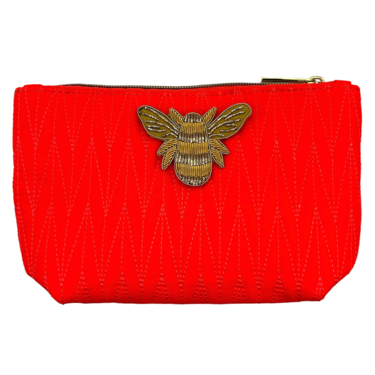 Orange Tribeca make up bag with a gold bee pin