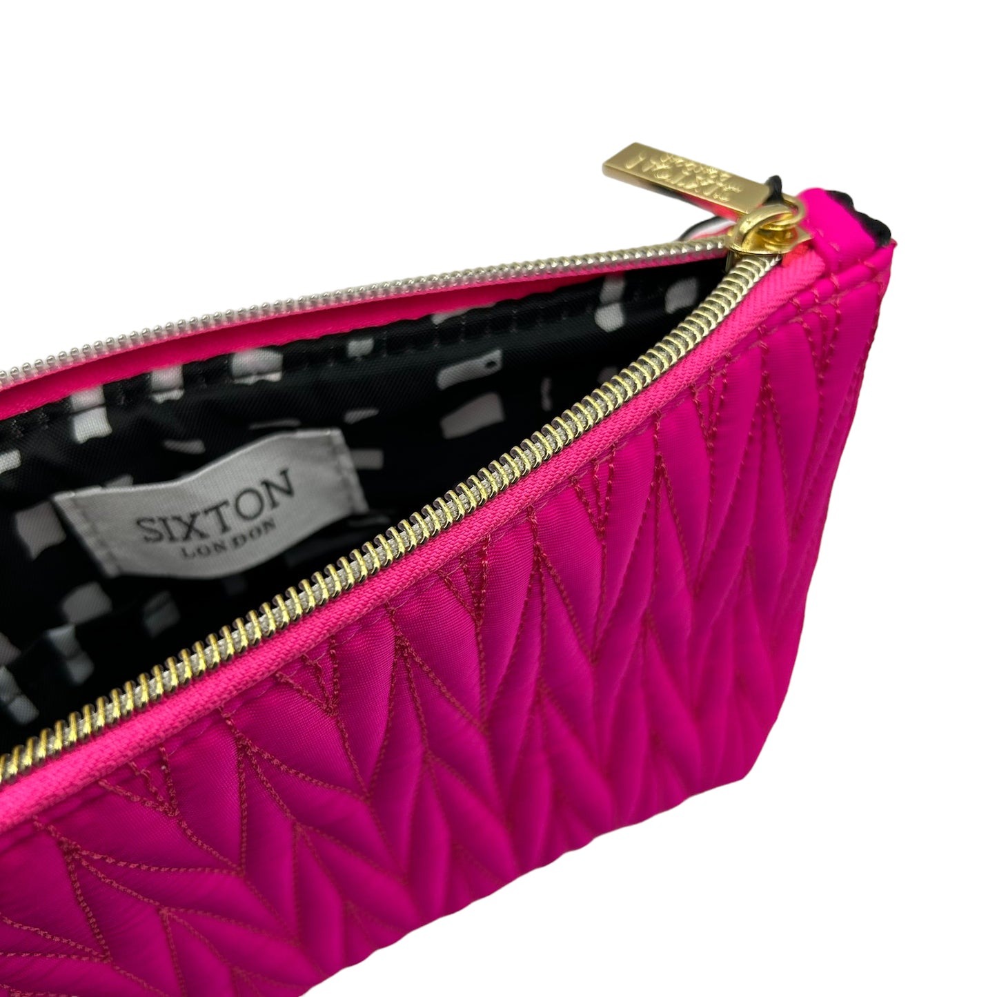 Bright pink Tribeca make up bag with a queen bee pin