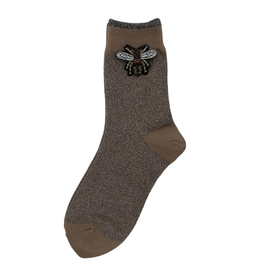 Tokyo socks in pewter with a grand insect brooch