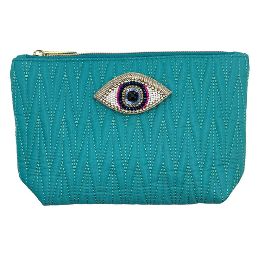 Turquoise Tribeca make up bag with a golden eye pin
