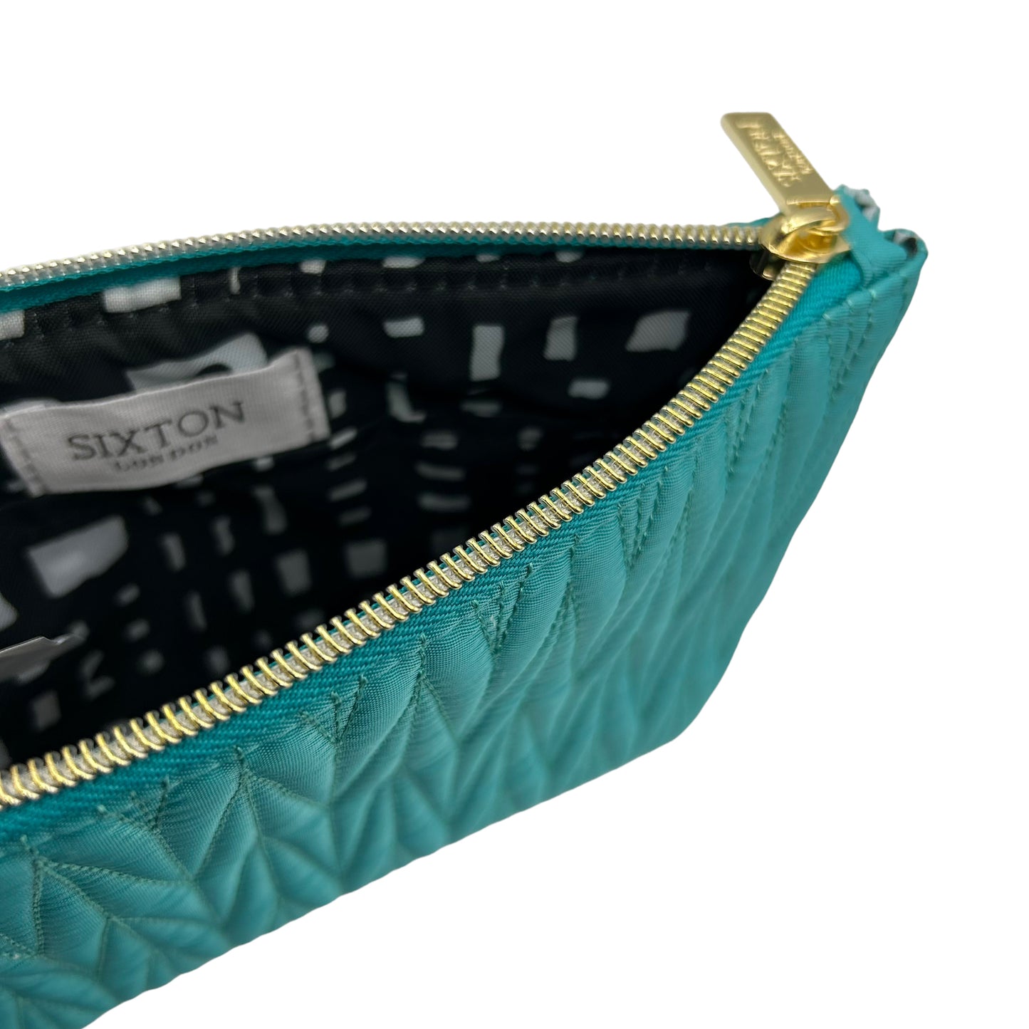 Turquoise Tribeca make up bag with a turquoise eye pin