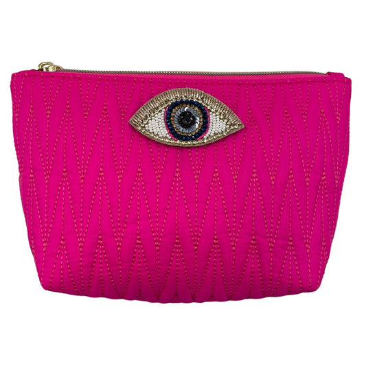 Bright pink Tribeca make up bag with a golden eye pin