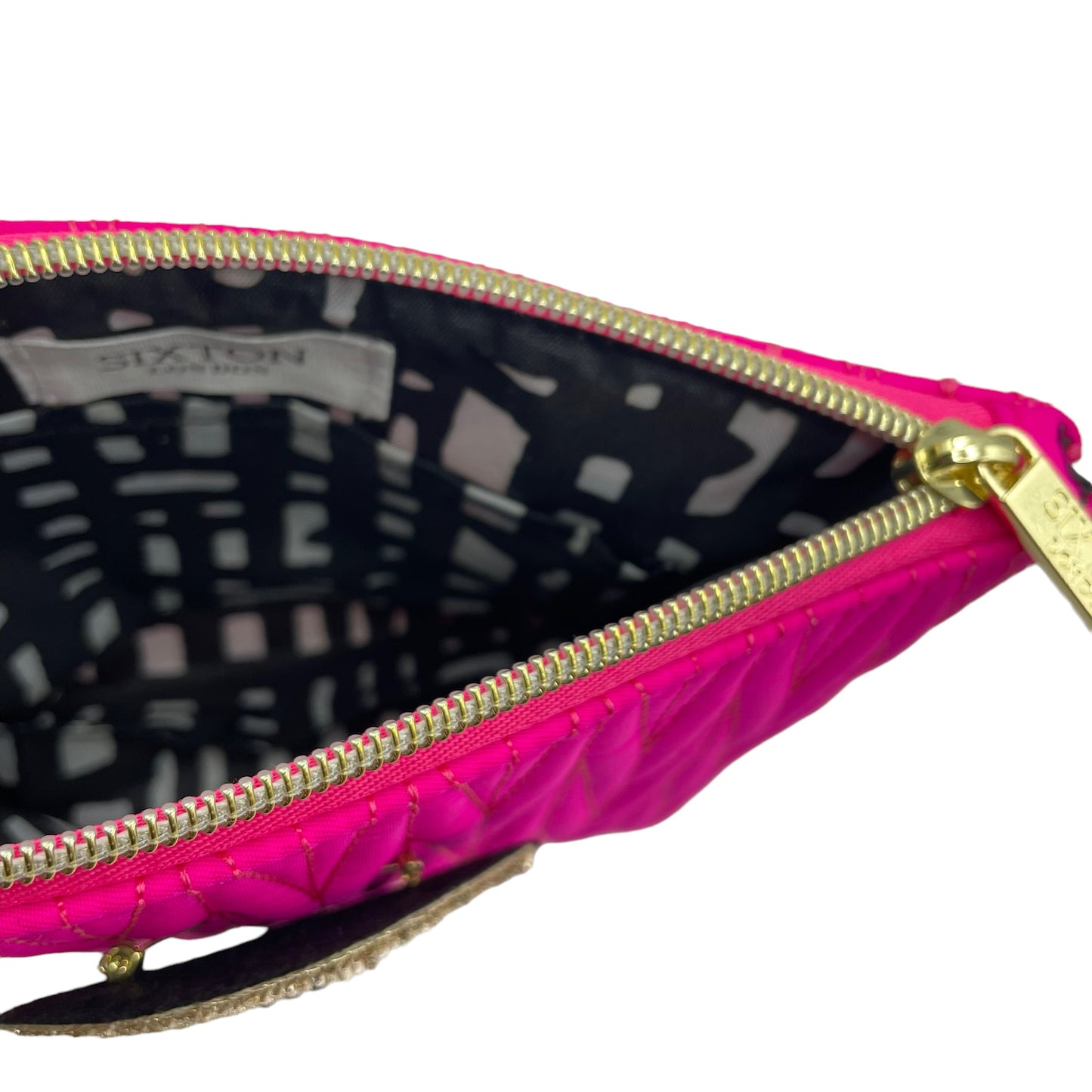 Bright pink Tribeca make up bag with a golden eye pin