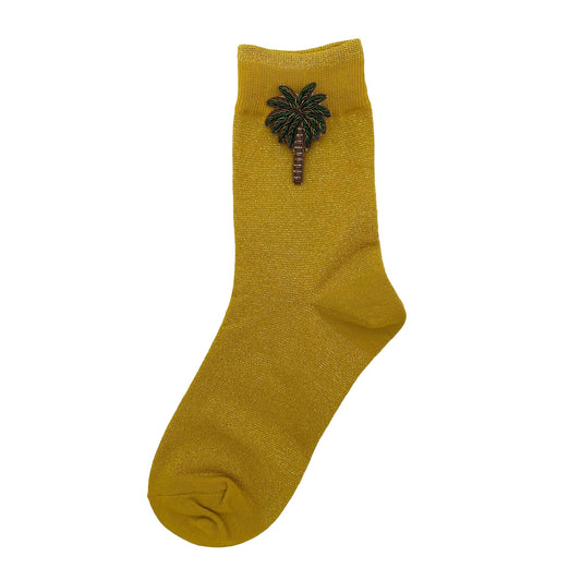 Tokyo socks in yellow with a palm tree pin